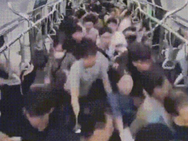 <p>Security footage shows a stampede that occured after a man pushed his way through a subway train, sparking fears of a mass stabbing and injuring at least 21 people</p>